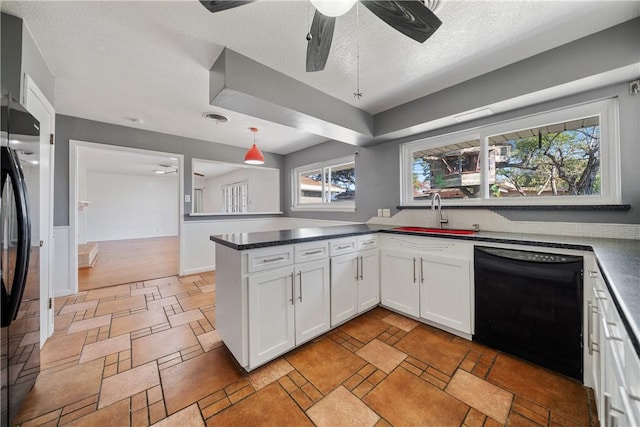 kitchen featuring a textured ceiling, white cabinets, black appliances, sink, and kitchen peninsula