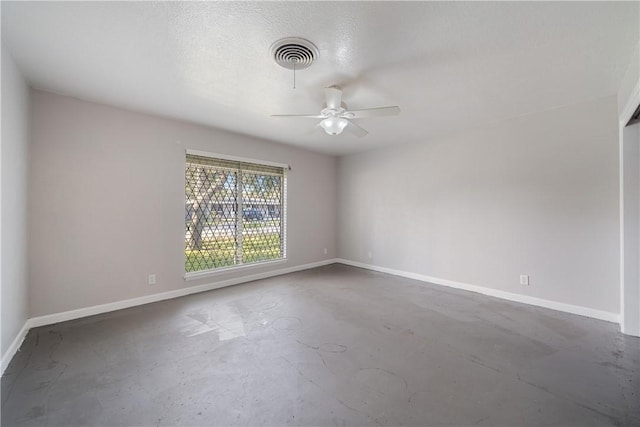 empty room featuring ceiling fan and concrete flooring