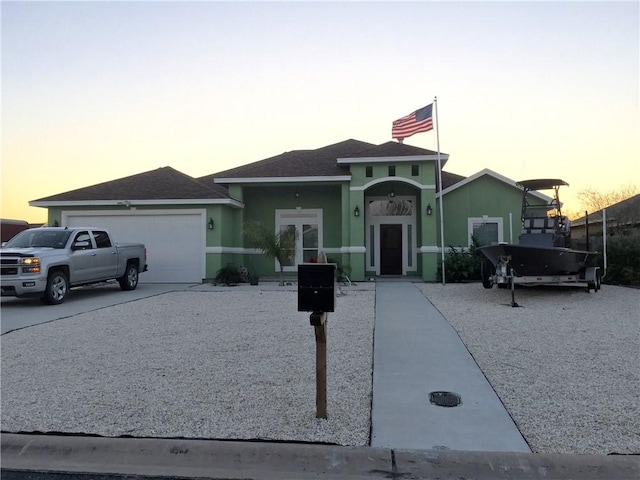 15533 Dyna St, Corpus Christi, TX 78418 - view of front of property with an attached garage, a shingled roof, and stucco siding