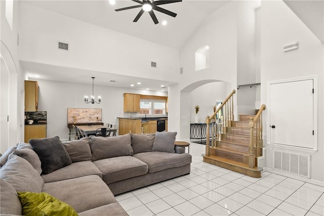 650 S Bay St, Aransas Pass, TX 78336 - living area with arched walkways, high vaulted ceiling, a ceiling fan, a chandelier, and light tile patterned flooring