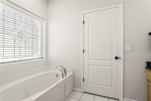 650 S Bay St, Aransas Pass, TX 78336 - bathroom featuring healthy amount of natural light, a tub with jets, vanity, and tile patterned floors