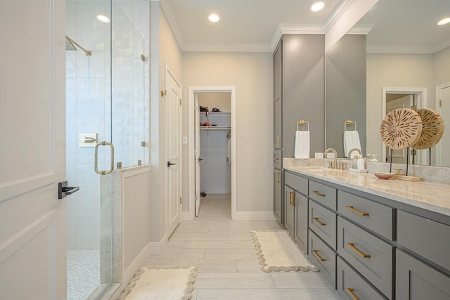 bathroom featuring vanity, an enclosed shower, and crown molding