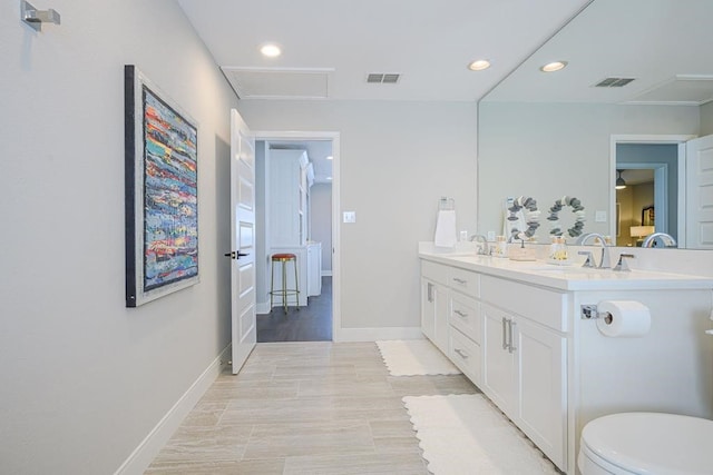 bathroom featuring hardwood / wood-style floors, vanity, and toilet