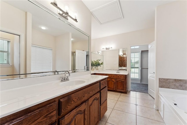 6530 Picante Dr, Corpus Christi, TX 78414 - bathroom with two vanities, a bath, and tile patterned flooring