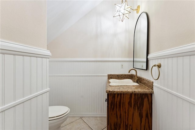 6530 Picante Dr, Corpus Christi, TX 78414 - bathroom featuring vanity, tile patterned flooring, a chandelier, lofted ceiling, and a wainscoted wall