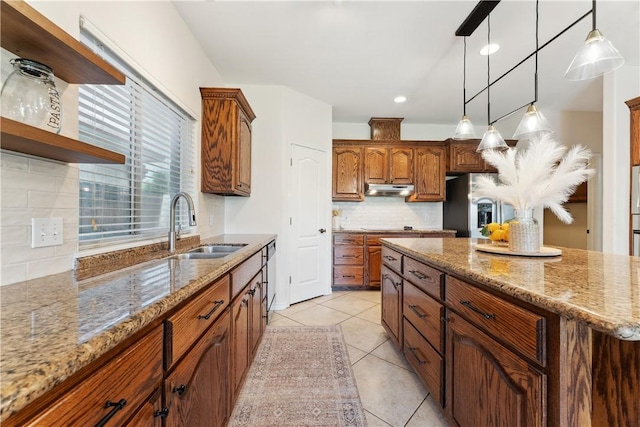6530 Picante Dr, Corpus Christi, TX 78414 - kitchen with backsplash, open shelves, stainless steel refrigerator with ice dispenser, under cabinet range hood, and decorative light fixtures