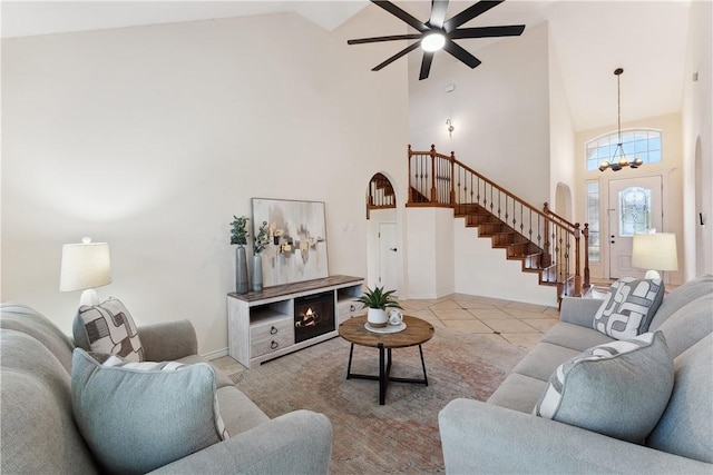6530 Picante Dr, Corpus Christi, TX 78414 - tiled living room with stairs, high vaulted ceiling, a chandelier, arched walkways, and ceiling fan