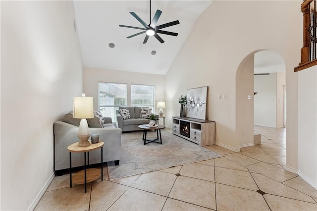 6530 Picante Dr, Corpus Christi, TX 78414 - living room with high vaulted ceiling, a ceiling fan, arched walkways, and light tile patterned floors