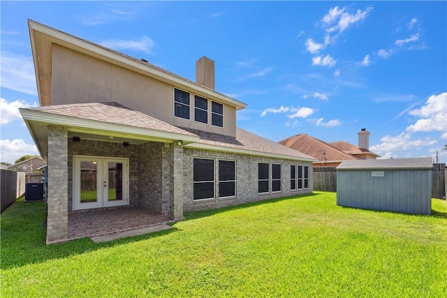 6530 Picante Dr, Corpus Christi, TX 78414 - back of house with french doors, a shed, a fenced backyard, a chimney, and roof with shingles