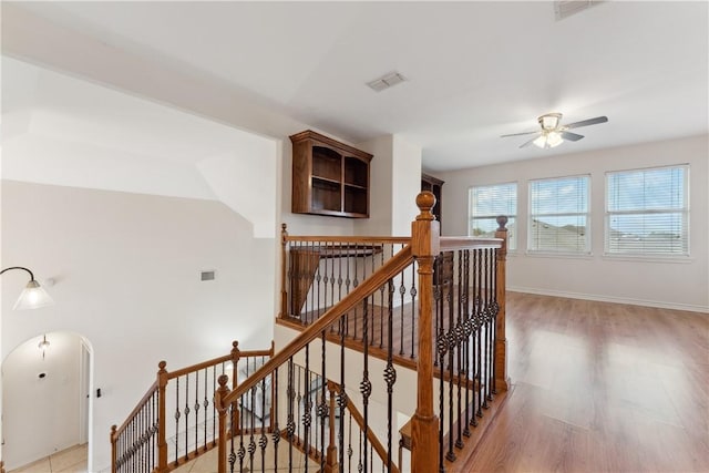 6530 Picante Dr, Corpus Christi, TX 78414 - staircase featuring a ceiling fan, wood finished floors, and arched walkways