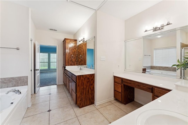 6530 Picante Dr, Corpus Christi, TX 78414 - bathroom with two vanities, a garden tub, and tile patterned floors