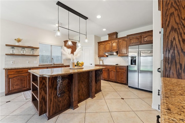 6530 Picante Dr, Corpus Christi, TX 78414 - kitchen featuring stainless steel fridge with ice dispenser, open shelves, under cabinet range hood, decorative backsplash, and light tile patterned floors