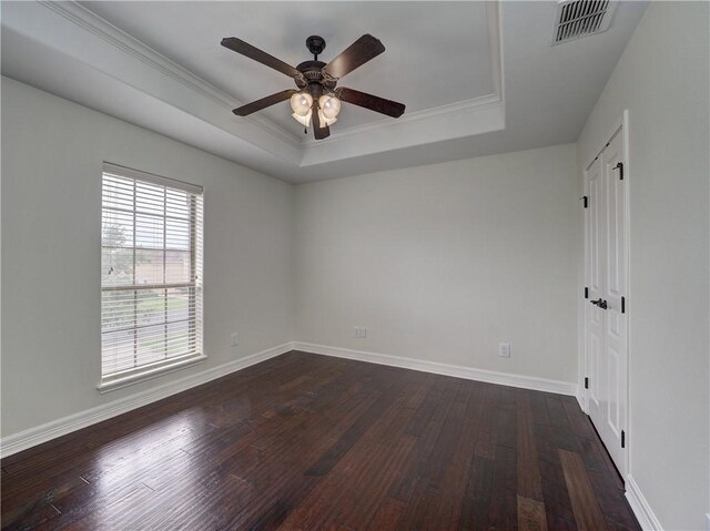 6134 Strasbourg Dr, Corpus Christi, TX 78414 - empty room with a tray ceiling, a ceiling fan, dark wood-style flooring, and ornamental molding