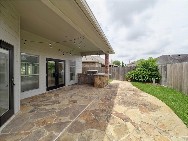 6134 Strasbourg Dr, Corpus Christi, TX 78414 - fenced backyard with an outdoor kitchen, a patio area, and french doors