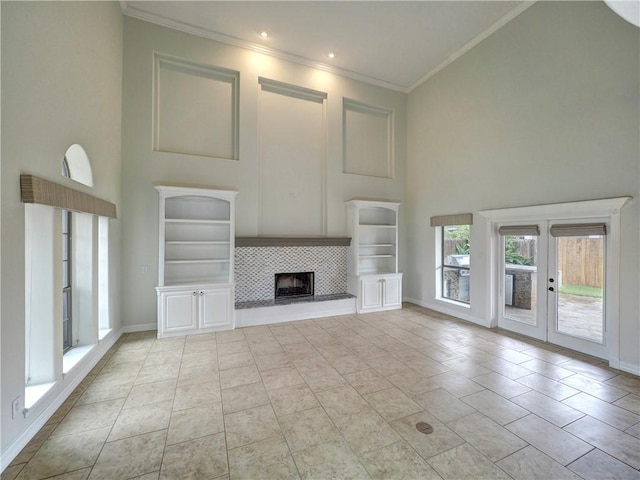 6134 Strasbourg Dr, Corpus Christi, TX 78414 - unfurnished living room with high vaulted ceiling, ornamental molding, a tile fireplace, and french doors