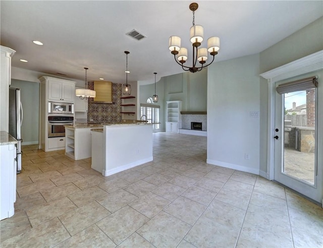 6134 Strasbourg Dr, Corpus Christi, TX 78414 - kitchen with stainless steel appliances, tasteful backsplash, open shelves, recessed lighting, and a kitchen island with sink