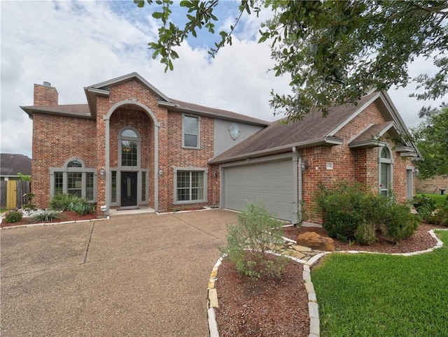 6134 Strasbourg Dr, Corpus Christi, TX 78414 - view of front of property with a chimney, driveway, an attached garage, and brick siding