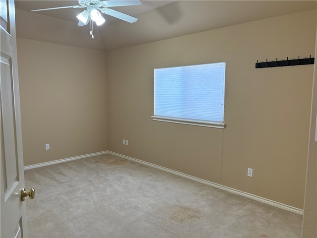 empty room featuring light carpet and ceiling fan