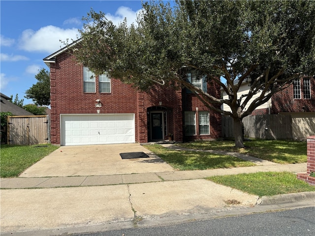 view of front of property with a garage and a front lawn