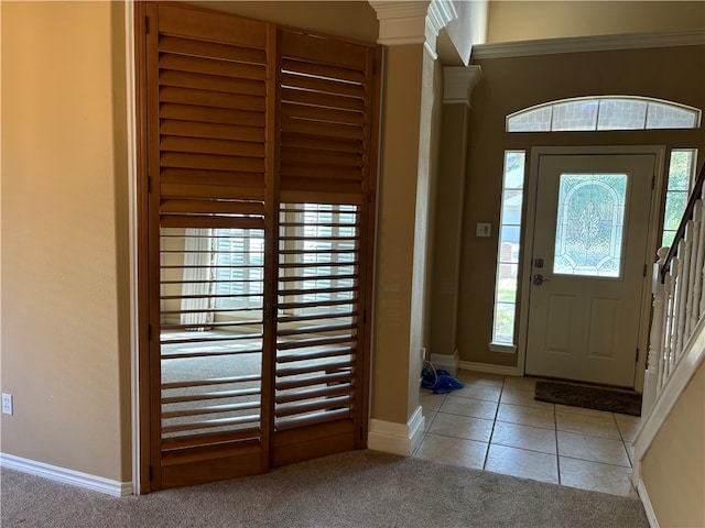 carpeted entrance foyer with decorative columns