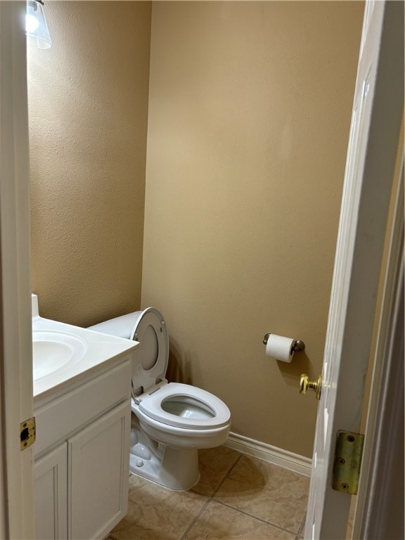 bathroom featuring toilet, vanity, and tile patterned floors