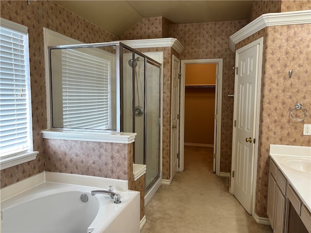 bathroom featuring vanity, independent shower and bath, and lofted ceiling