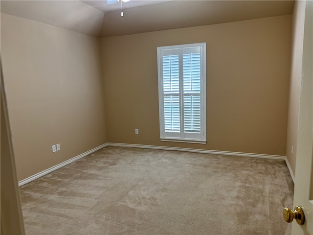 unfurnished room with light carpet, ceiling fan, and vaulted ceiling