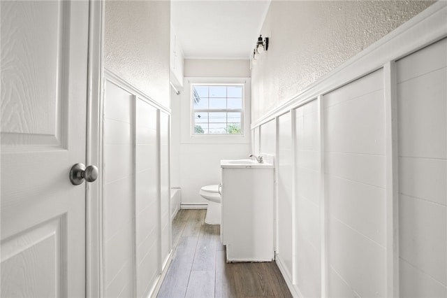 1367 Normandy Dr, Corpus Christi, TX 78415 - full bathroom with toilet, wood finished floors, vanity, a textured wall, and ornamental molding