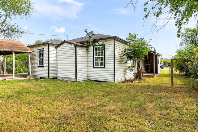 1367 Normandy Dr, Corpus Christi, TX 78415 - rear view of property featuring a yard and a carport