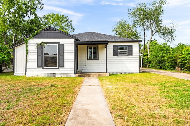 1367 Normandy Dr, Corpus Christi, TX 78415 - bungalow-style house featuring a front lawn, a porch, and a shingled roof