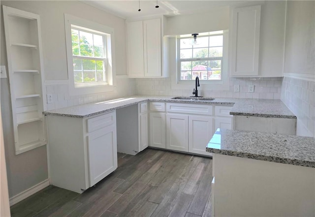 1367 Normandy Dr, Corpus Christi, TX 78415 - kitchen featuring a sink, light stone counters, plenty of natural light, and dark wood-style floors