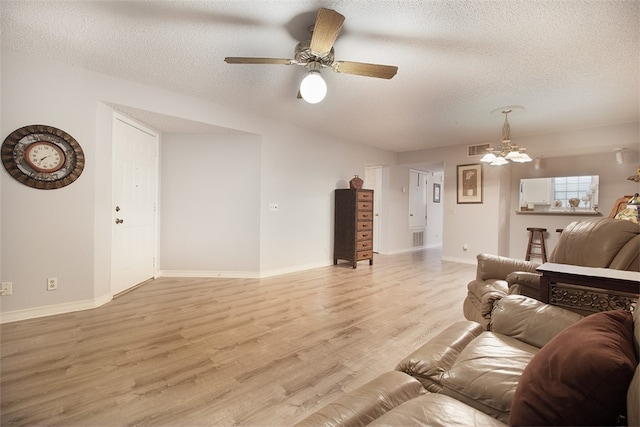 4445 Cedar Pass Dr Unit 103, Corpus Christi, TX 78413 - living area featuring ceiling fan, a textured ceiling, light wood finished floors, and a chandelier