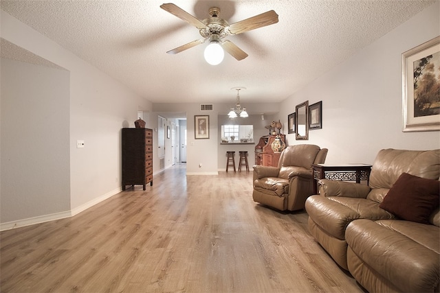 4445 Cedar Pass Dr Unit 103, Corpus Christi, TX 78413 - living room with light wood-style flooring, a textured ceiling, ceiling fan, and a chandelier