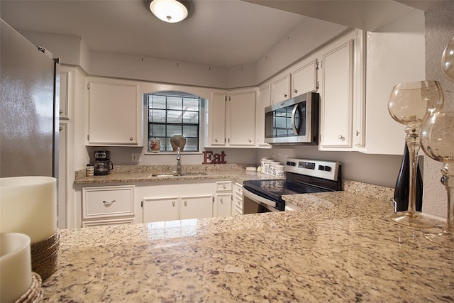 4445 Cedar Pass Dr Unit 103, Corpus Christi, TX 78413 - kitchen featuring appliances with stainless steel finishes, white cabinets, and light stone counters