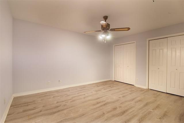 4445 Cedar Pass Dr Unit 103, Corpus Christi, TX 78413 - unfurnished bedroom featuring two closets, light wood-type flooring, and a ceiling fan