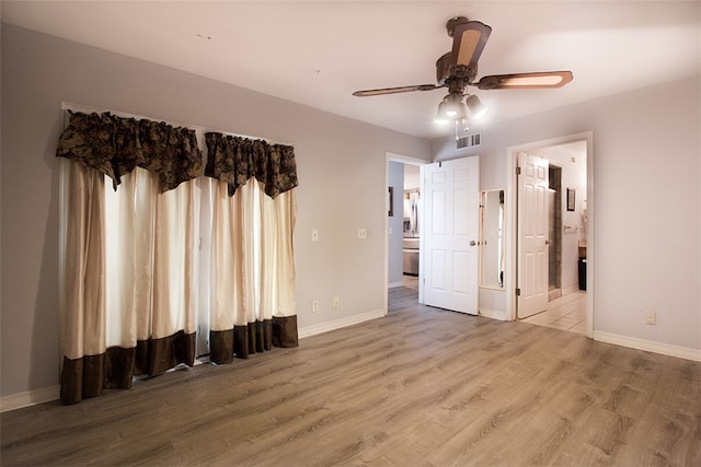 4445 Cedar Pass Dr Unit 103, Corpus Christi, TX 78413 - unfurnished bedroom featuring wood finished floors, connected bathroom, stainless steel refrigerator with ice dispenser, and ceiling fan