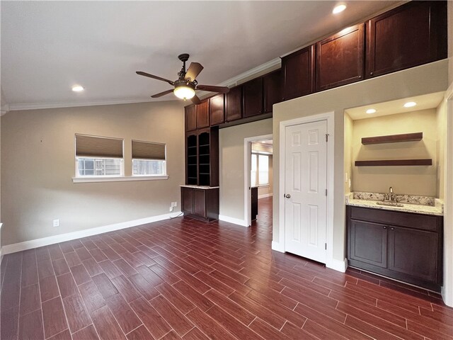 kitchen with a wealth of natural light, dark hardwood / wood-style flooring, crown molding, and lofted ceiling