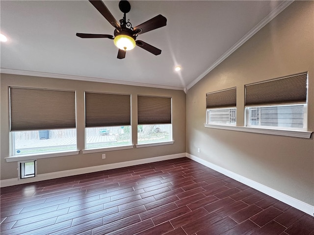 empty room featuring dark hardwood / wood-style floors, vaulted ceiling, ceiling fan, and ornamental molding