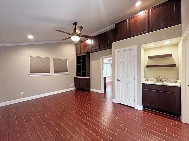 interior space featuring lofted ceiling, sink, crown molding, dark hardwood / wood-style floors, and ceiling fan