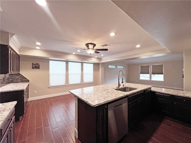 kitchen featuring a kitchen island with sink, sink, stainless steel dishwasher, dark hardwood / wood-style floors, and light stone counters