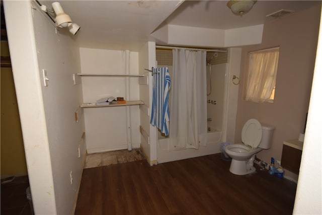 bathroom featuring hardwood / wood-style floors, toilet, and shower / tub combo