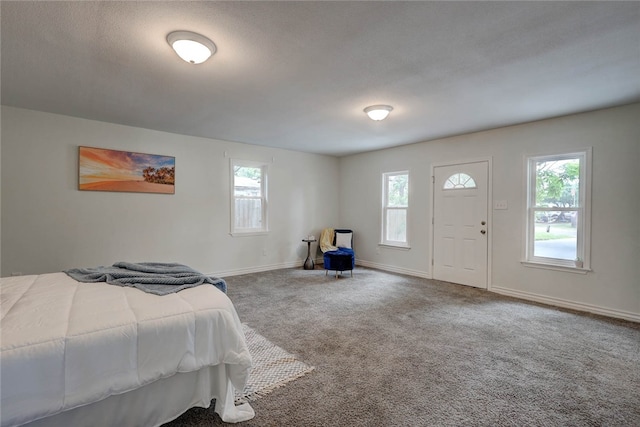 bedroom with a textured ceiling and carpet floors