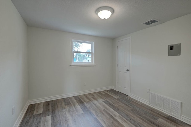 empty room featuring hardwood / wood-style floors and a textured ceiling