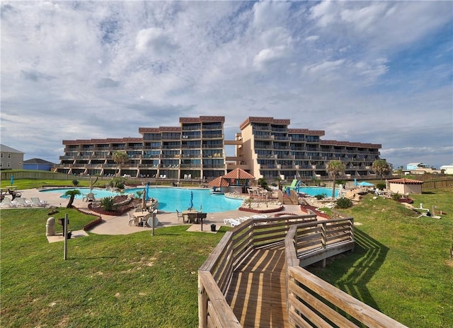 view of swimming pool featuring a lawn and a patio