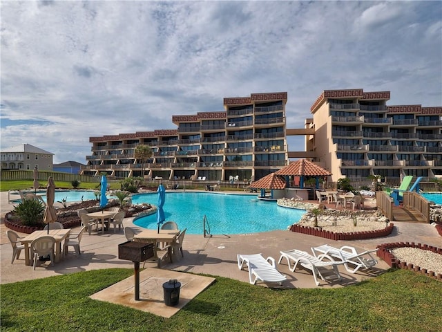 view of swimming pool with a lawn and a patio area