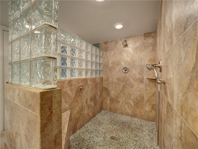 bathroom with a tile shower