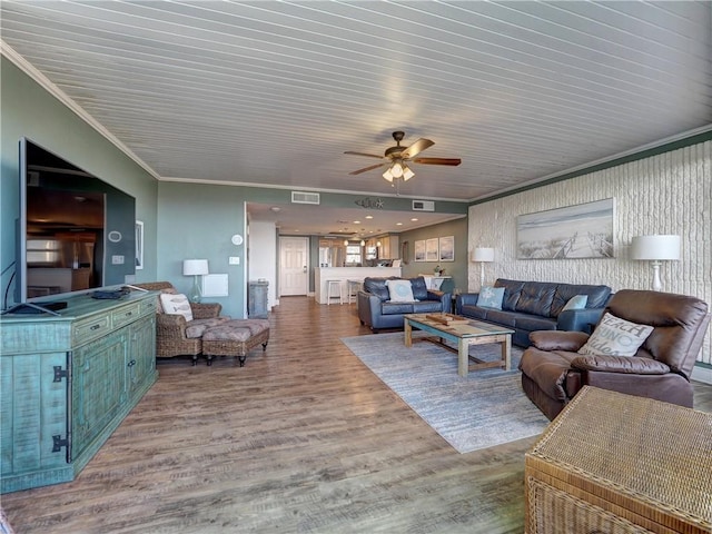 living room with crown molding, ceiling fan, and hardwood / wood-style flooring