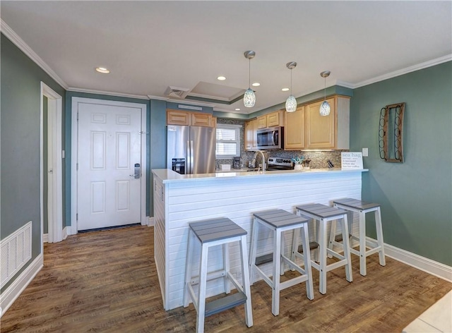 kitchen featuring hanging light fixtures, stainless steel appliances, dark wood-type flooring, kitchen peninsula, and crown molding