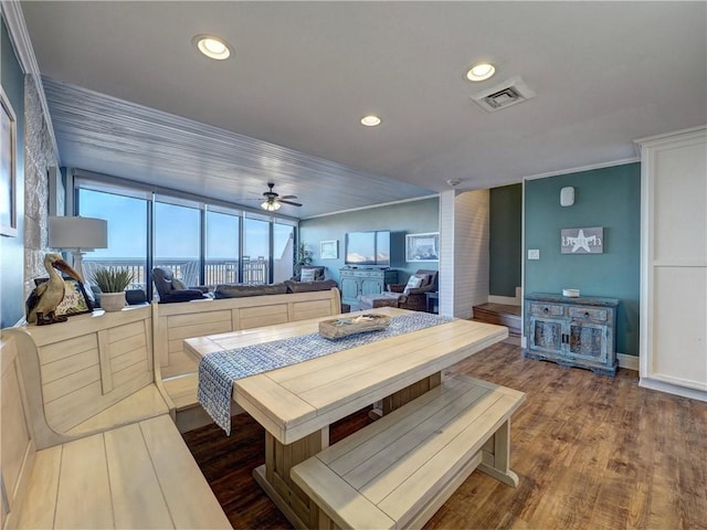 dining room featuring wood-type flooring, ceiling fan, and ornamental molding