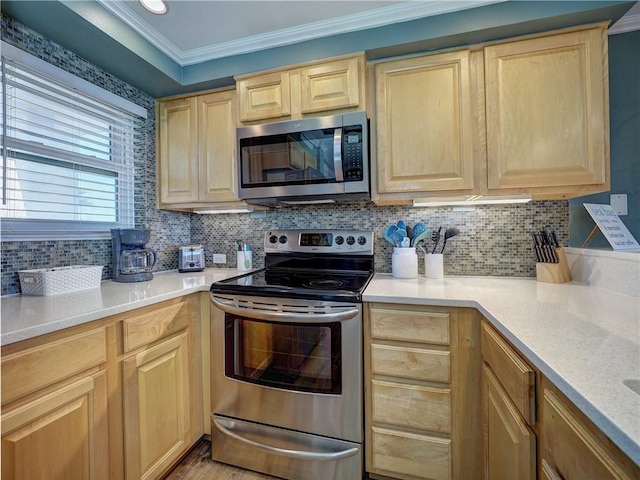 kitchen with light brown cabinets, stainless steel appliances, and tasteful backsplash